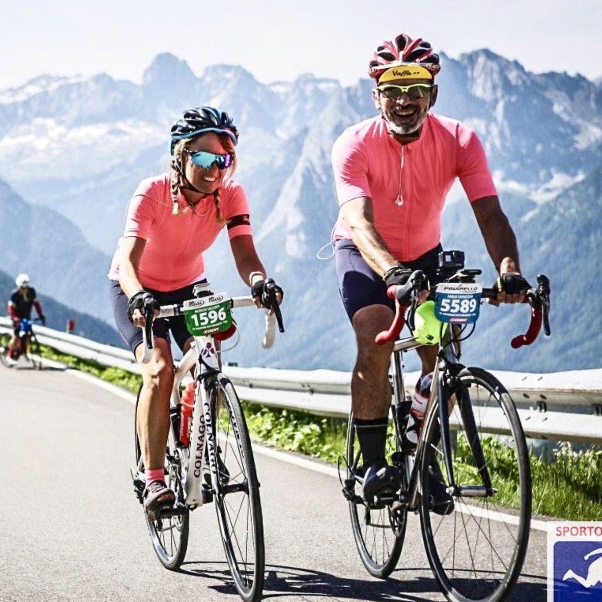 A couple riding bikes in the mountains.