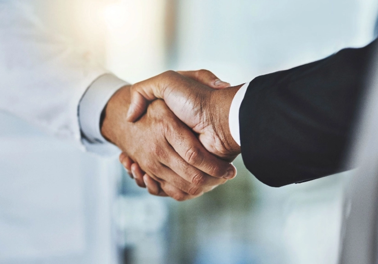 A closeup of two hands shaking.