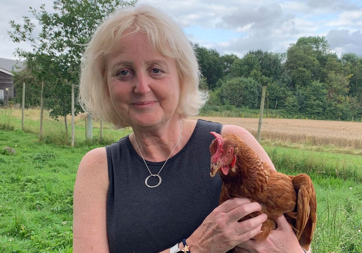 Debra Montague holding a chicken.