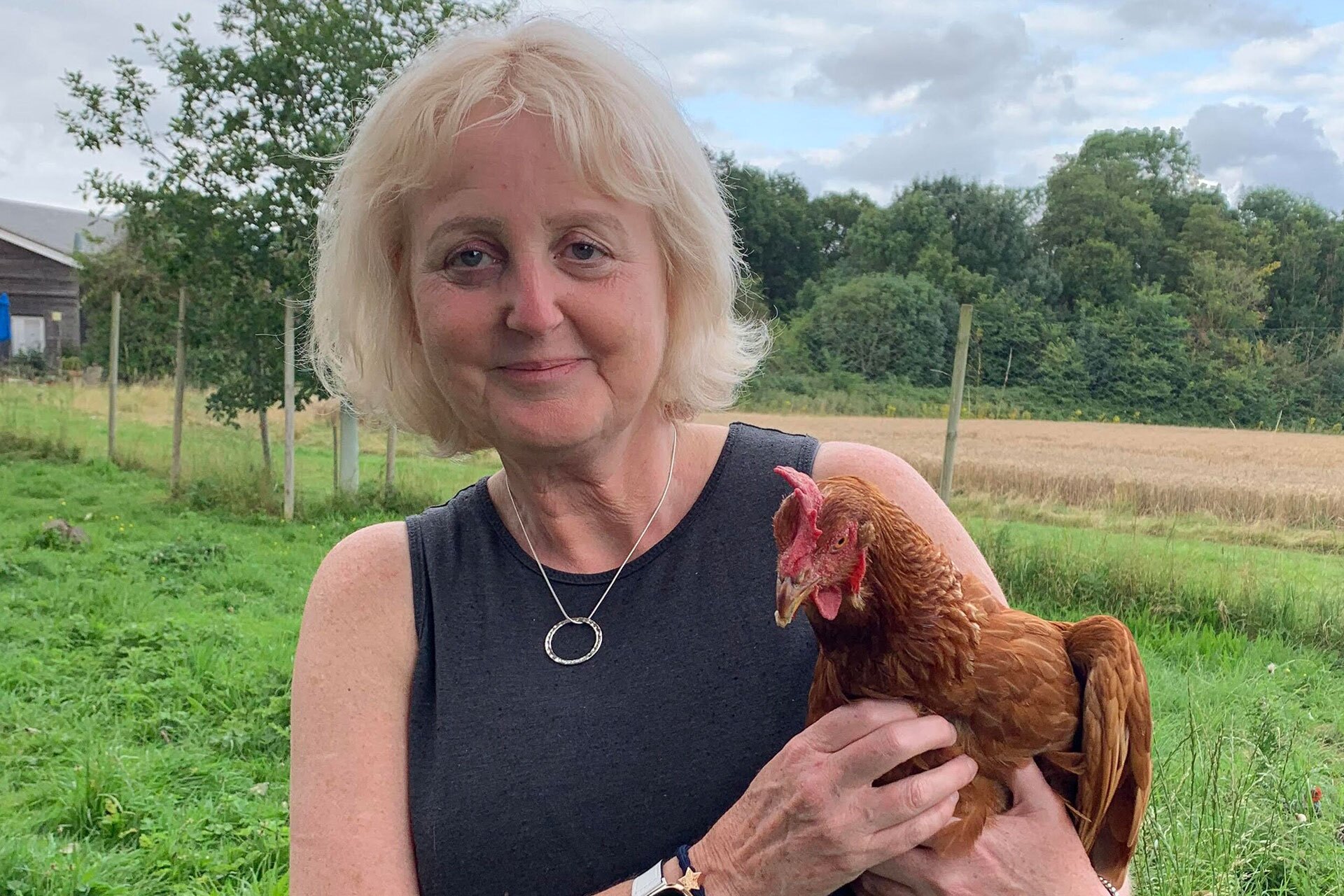 Debra Montague holding a chicken.