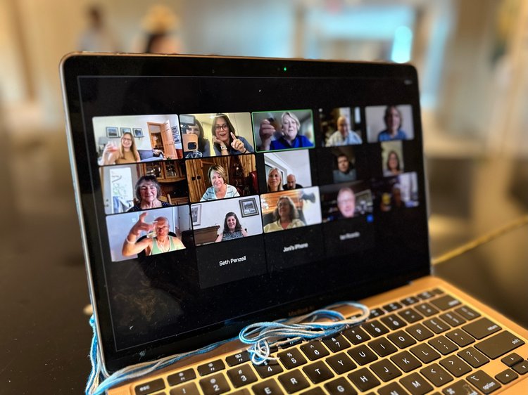 A grid of people participating in a video chat on a laptop screen.